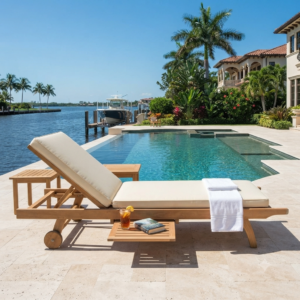 Premium Indonesian teak sun lounger placed on a luxury Florida villa pool deck with ocean view.